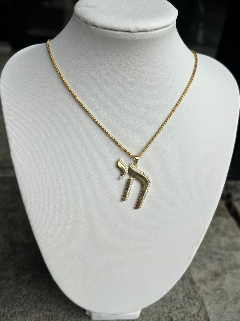 Chai Charm Necklace available in gold and silver.