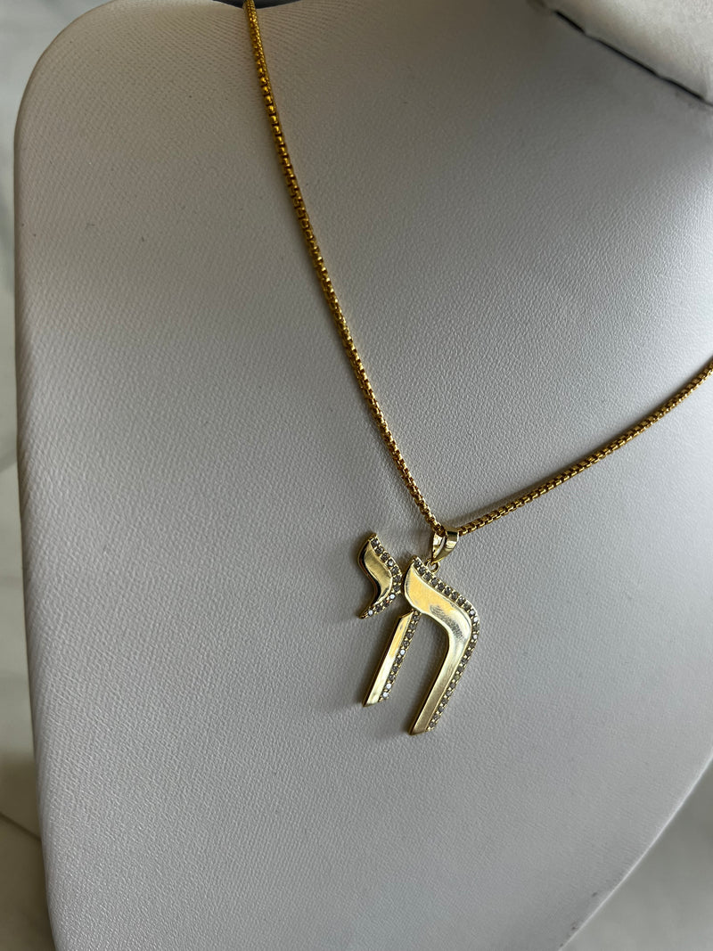 Chai Charm Necklace available in gold and silver.